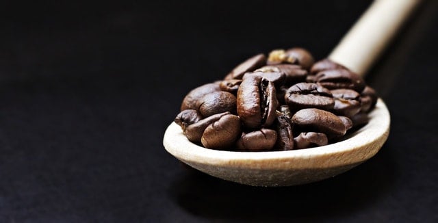 Coffee beans on a wooden spoon
